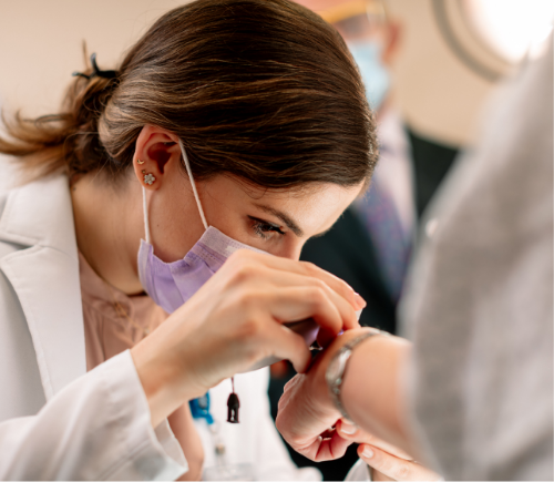 Doctor examining patient hand