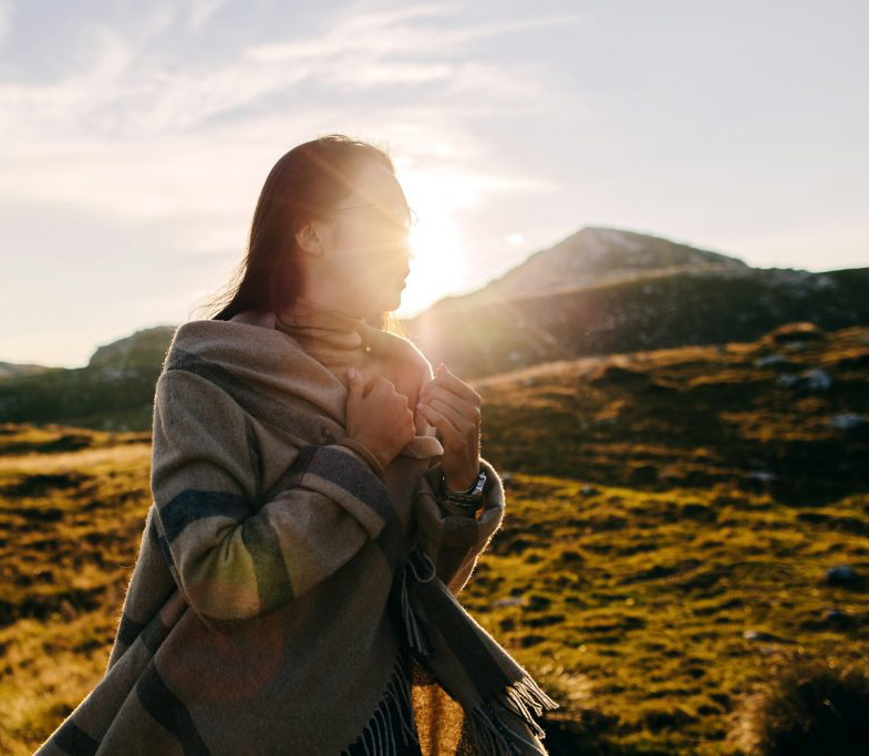 Person walking on grassy hills