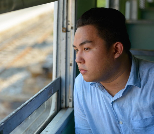 Man looking out bus window