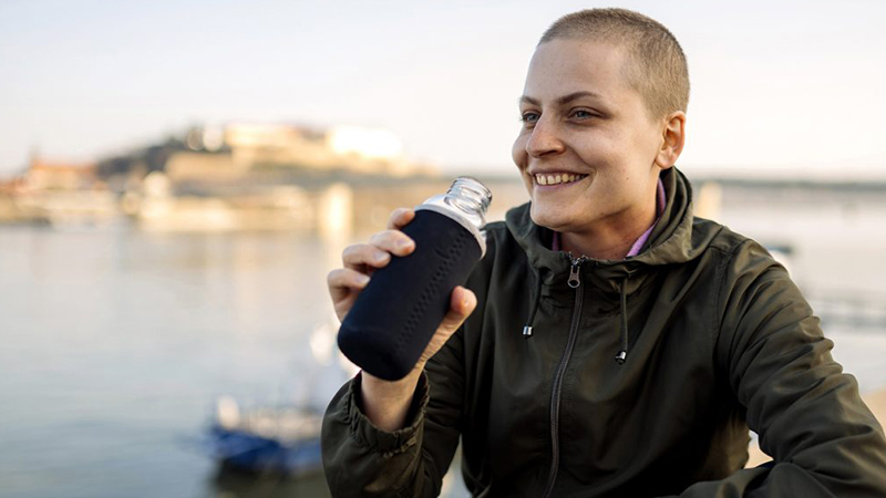 Woman smiling in front of the water