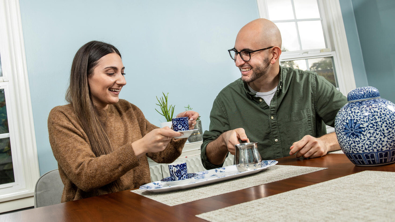 Woman and man drinking tea at table