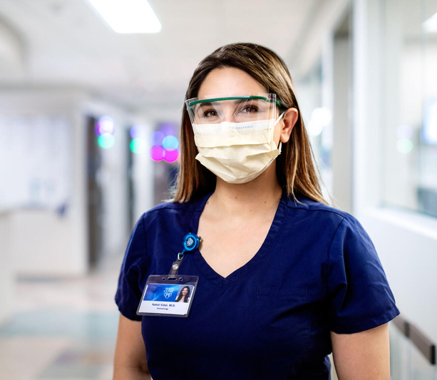 Doctor smiling in mask and glasses