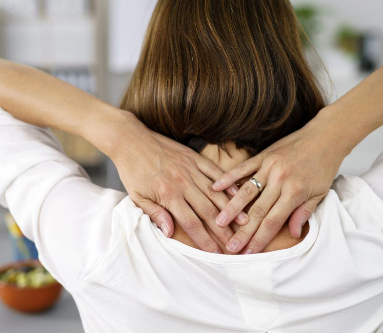 Woman stretching with hands behind her neck