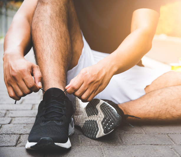 Person tying tennis shoes