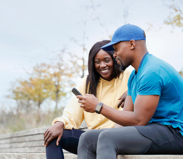 People looking at phone in park