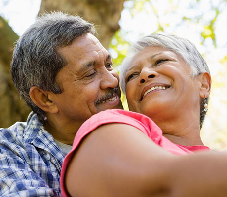 Woman and man hugging and looking at each other