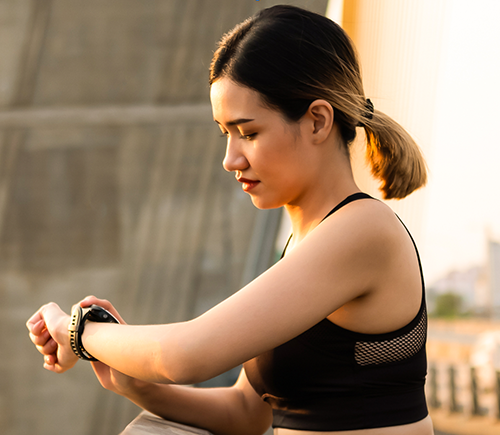 Woman runner checking her watch