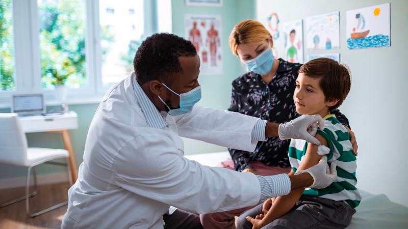 Doctor putting a bandage on a child