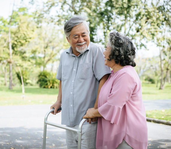 Older couple walking together outside