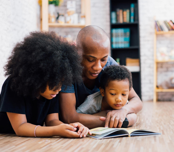 Father reading with two children