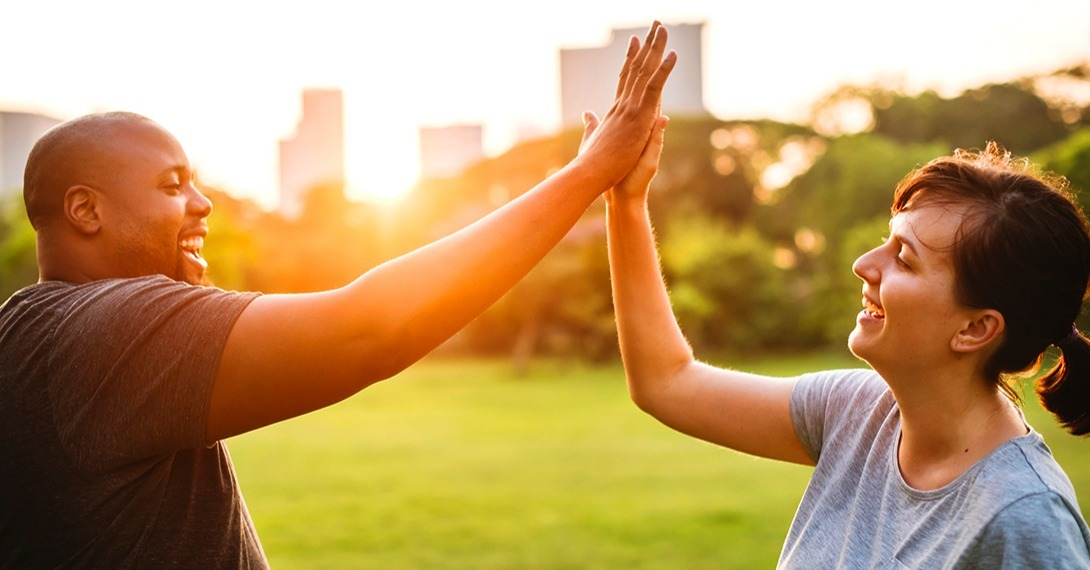 Couple work out high five.