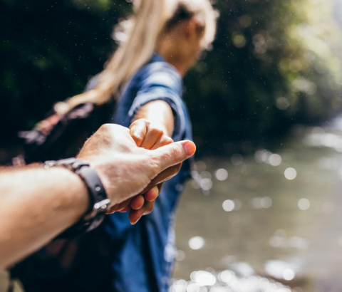 Woman leading man on an outdoor adventure