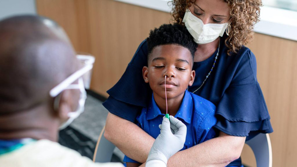 Child getting nose swabbed