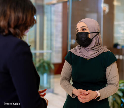 Translator talking with masked patient