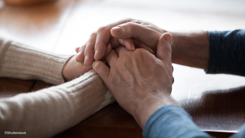 Adults holding hands