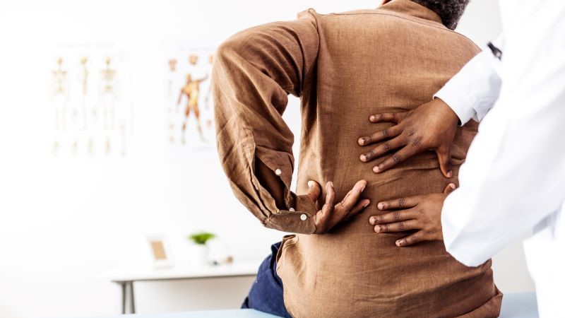 Doctor examining a patients back