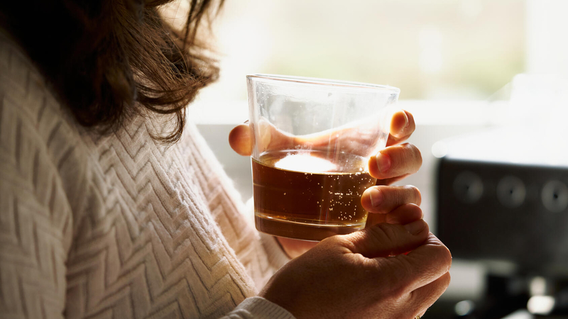 Woman with an alcohlic beverage in her hand