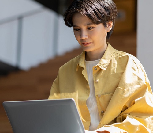 Young person using laptop.