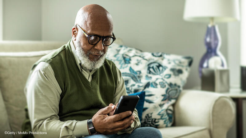 Older adult man using cellphone