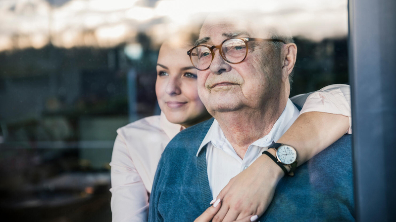 Woman hugging dad and looking out window