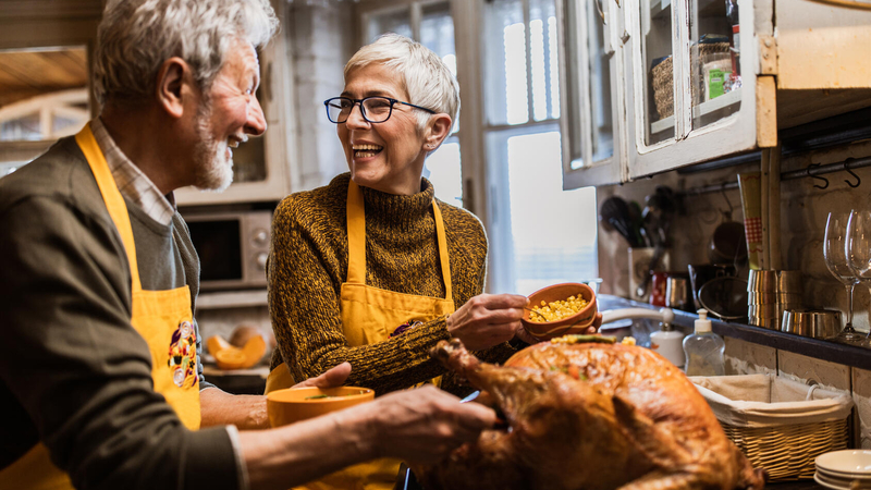 A couple cook a turkey