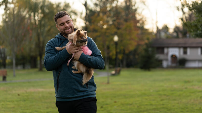 Man holding small dog