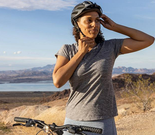 Cyclist adjusting their helmet