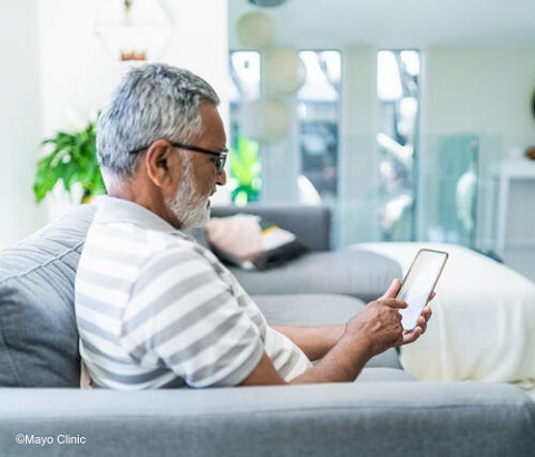 Elderly man using smarphone.