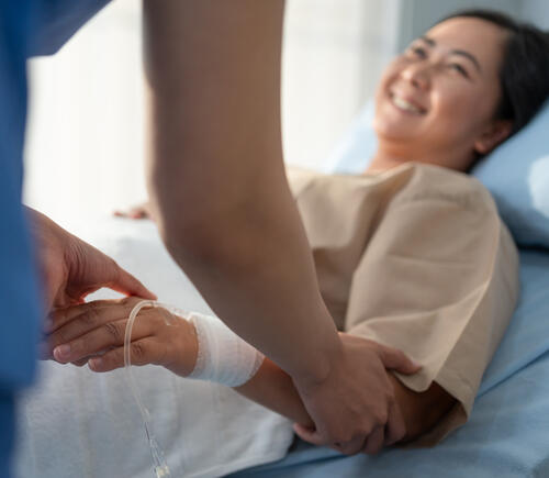 Nurse helping patient with IV