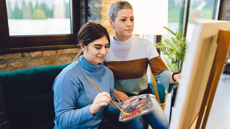 Woman taking a painting class