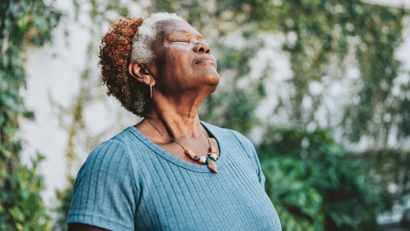 Older Black woman inhaling