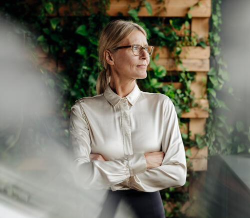 Woman with folded arms looking off camera