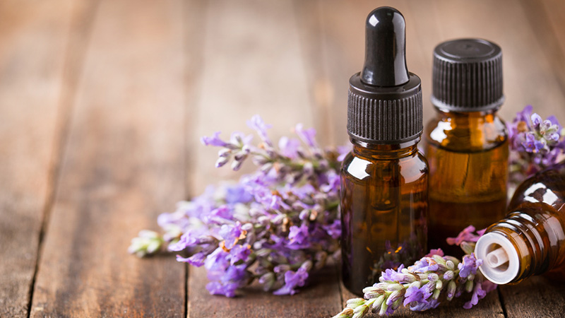 Vials of essential oils and fresh sprigs of lavender