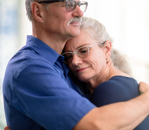 Two adults embracing.