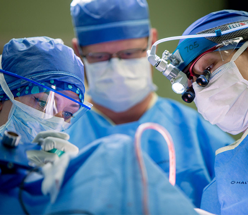 Three masked doctors in surgery