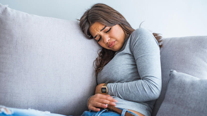 Woman holding her stomach in pain