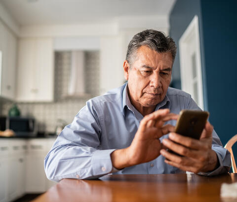 Older man using his phone