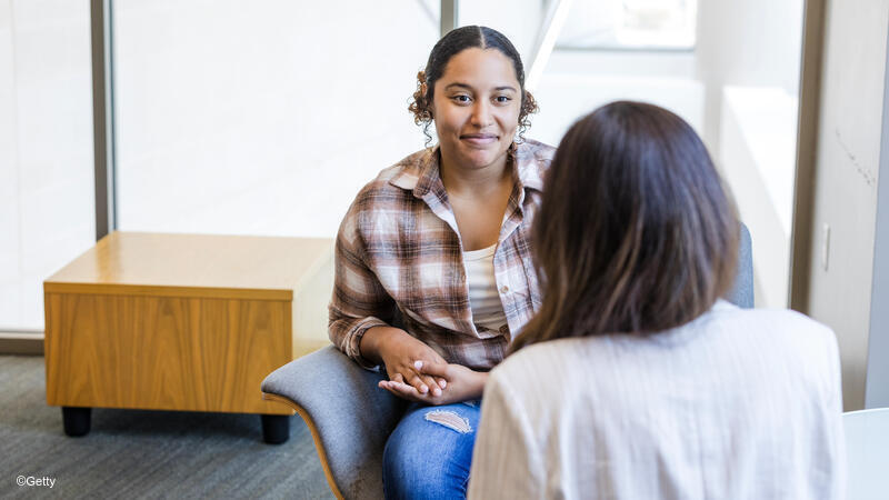 Young woman speaking to a female therapist