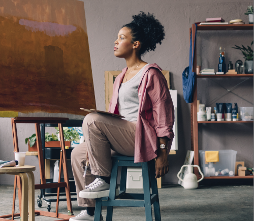 Woman sitting in painting studio