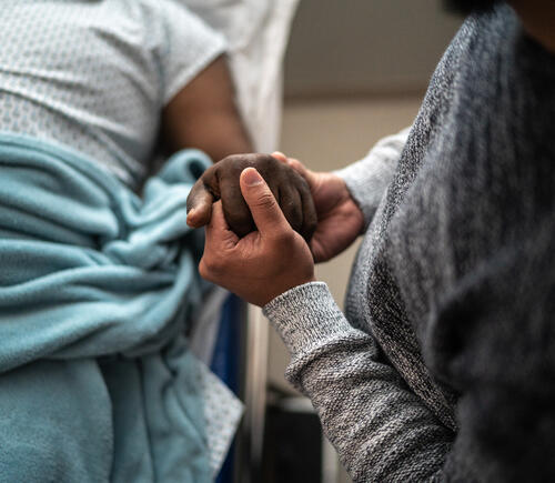 Person holding hand of a patient
