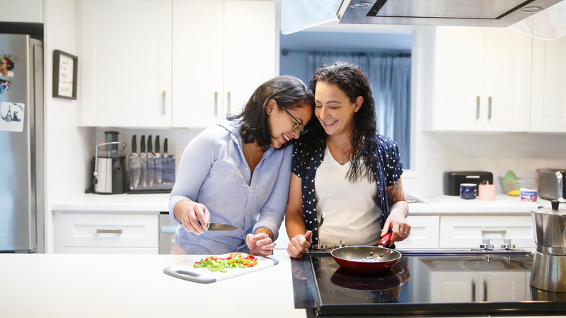 Two women cooking together in kitchen