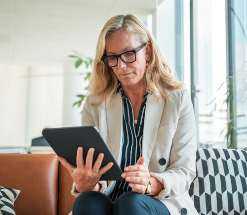 Woman with glasses on e-tablet