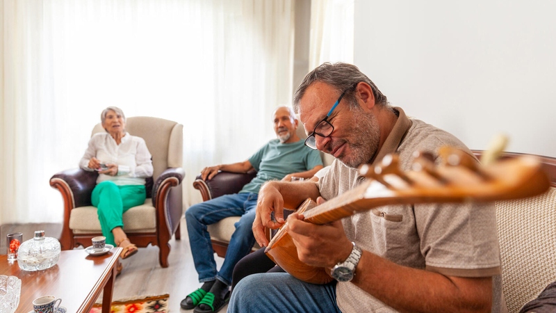 Group sitting on couches playing music and singing