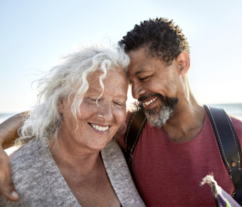 Two people smiling and embracing