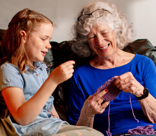 Grandmother and granddaughter knitting