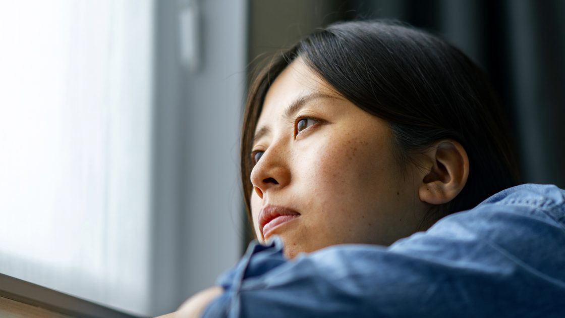 Woman looking out window