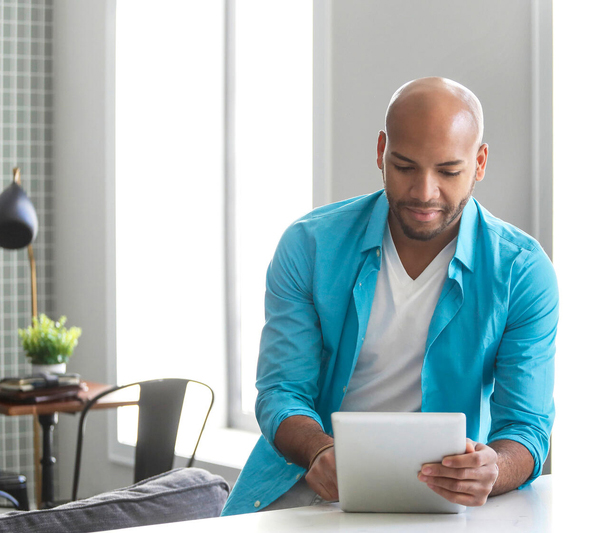 Man working on iPad on counter