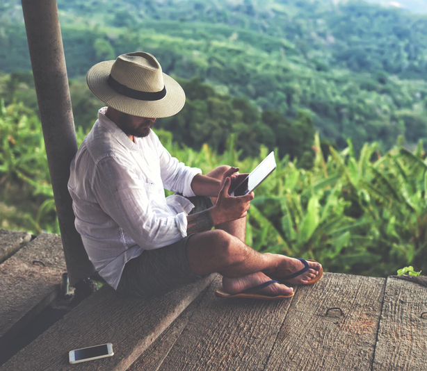 Man sitting outside using tablet