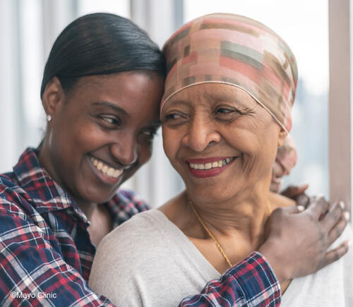 Two women embracing each other