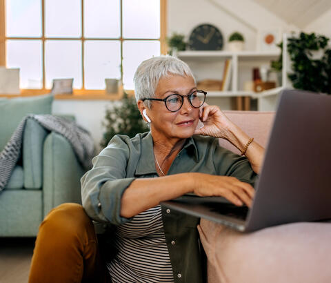 Older woman using a laptop at home